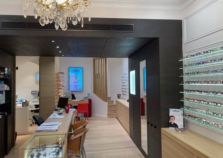 intérieur d'un magasin d'optique avec des rayons de lunettes de vue