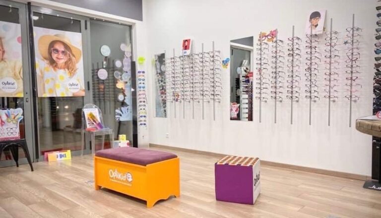 espace enfant d'un magasin d'optique avec des rayons de lunettes de vue